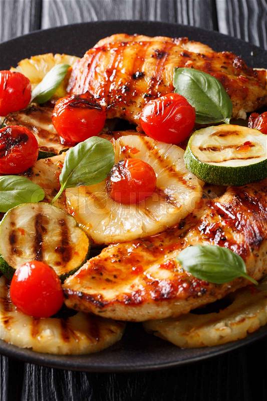 Delicious barbecue: Grilled chicken breast with pineapple, zucchini and tomatoes close-up. vertical , stock photo