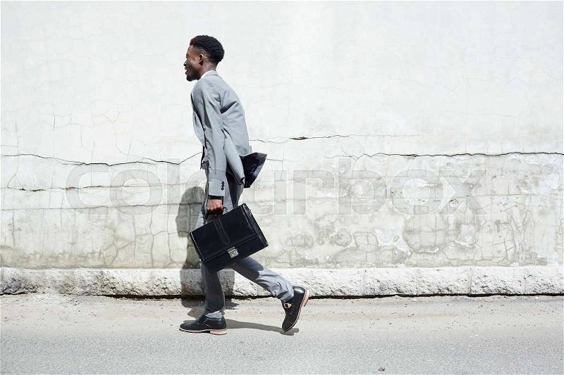 Businessman in suit hurrying somewhere, stock photo