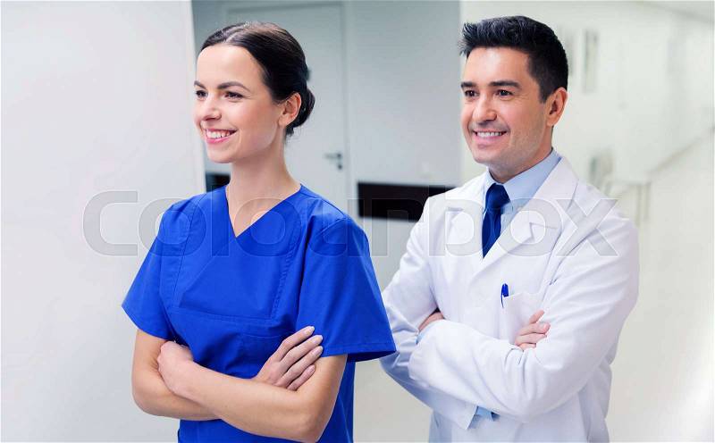 Healthcare, profession, people and medicine concept - smiling doctor in white coat and nurse at hospital, stock photo