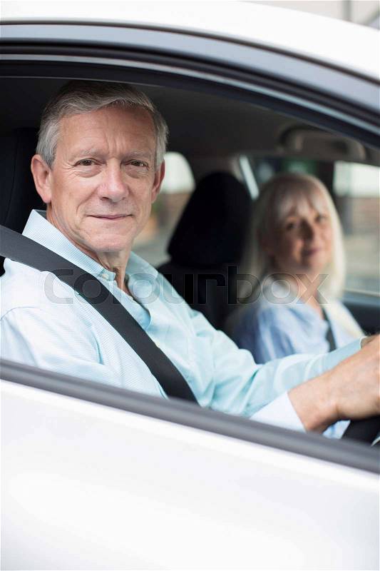 Portrait Of Smiling Mature Couple On Car Journey Together, stock photo