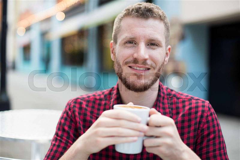 Portrait Of Young Man Drink Coffee At Outdoor Cafe Table, stock photo