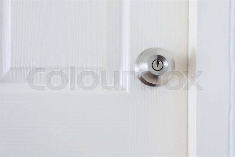 White wood pane door closed and silver knob lock in industrial building house, stock photo