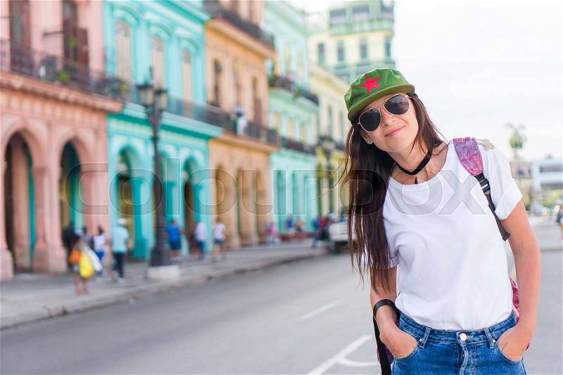 Young woman in popular area in old Havana, Cuba. Beautiful girl traveler background colorful houses in the city, stock photo