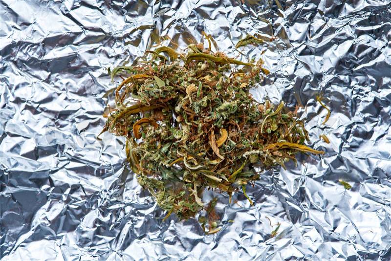 Medical cannabis ready to use on foil background, stock photo