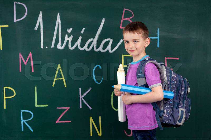 The boy goes to the first class at the school board, stock photo