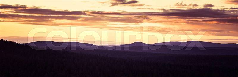 A beautiful landscape with a midnight sun above arctic circle. Dreamy scenery with light flares, stock photo
