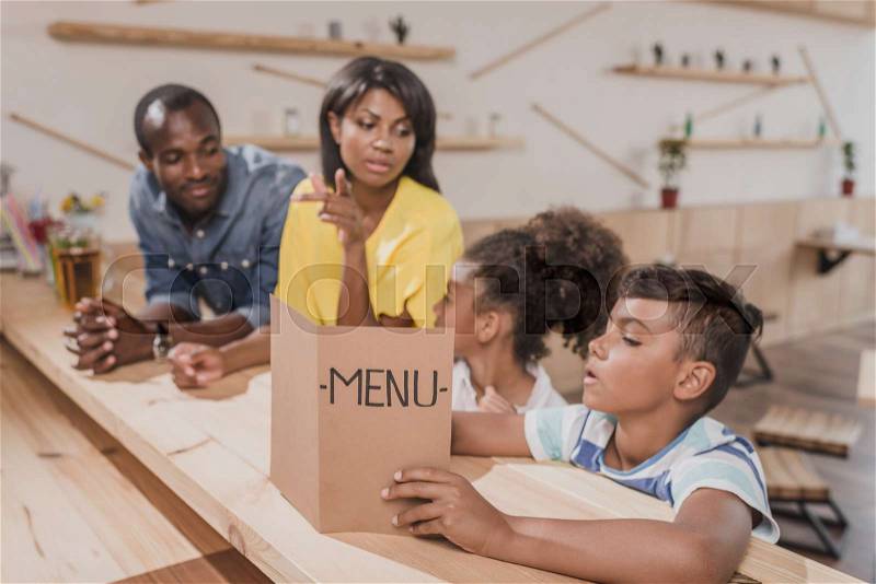 African-american family in cafe at bar counter, stock photo