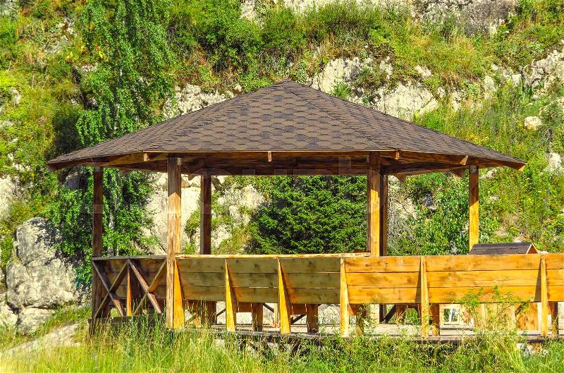 Large wooden pavilion in the summer forest, stock photo