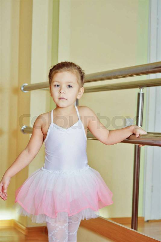 Sweet little girl in dance school studio, stock photo
