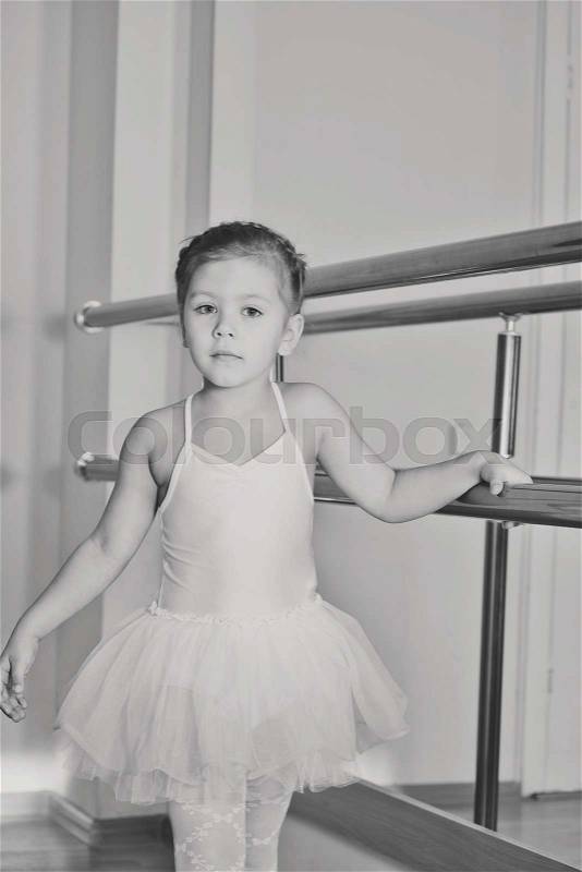 Sweet little girl in dance school studio, stock photo