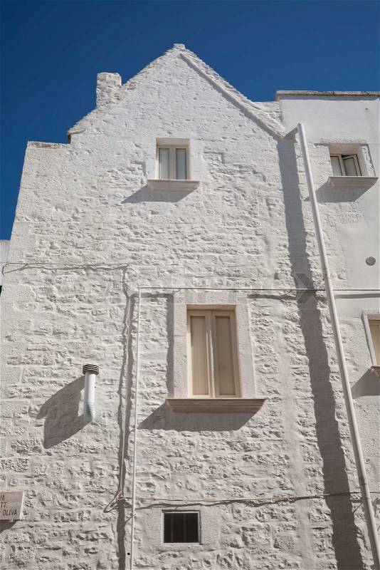 White painted building againt a nice blue September sky - Martina Franca, Apulia - Italy, stock photo