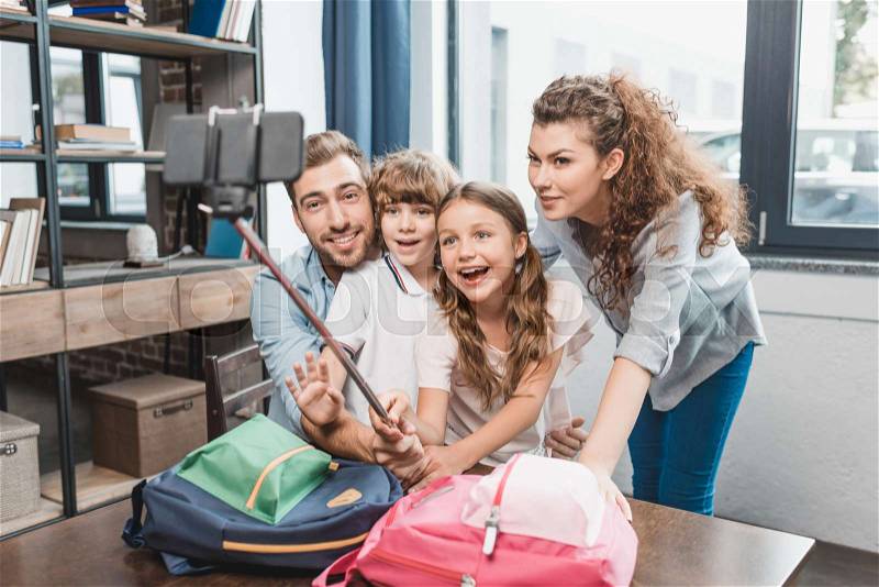 Family taking selfie before first day at school, stock photo