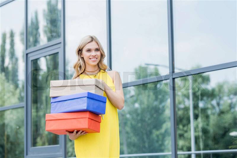 Beautiful happy blonde woman with shoe boxes, stock photo