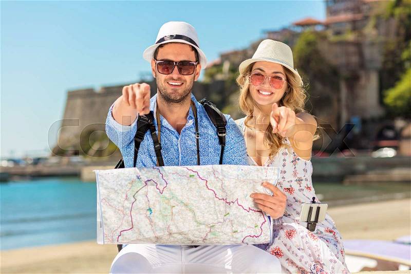 Couple tourist traveling and using map. Couple tourist exploring a city, stock photo
