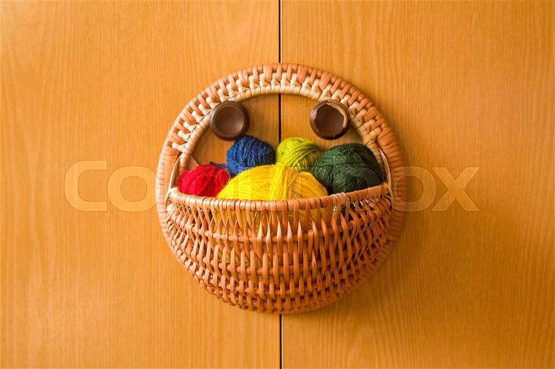 A beautiful, colorful yarn balls in a handmade basket, stock photo