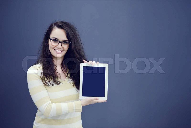 Surprised young woman using holding a digital tablet, stock photo