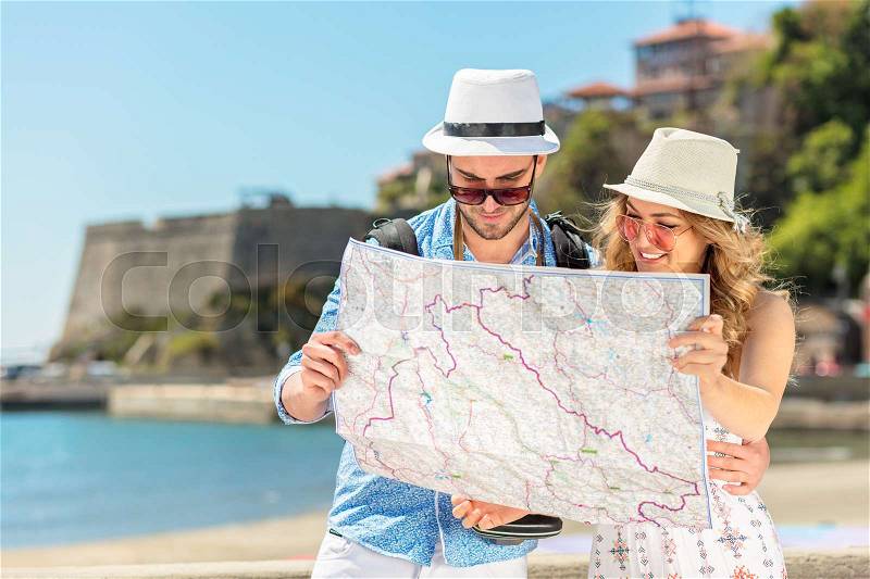 Couple tourist traveling and using map. Couple tourist exploring a city, stock photo