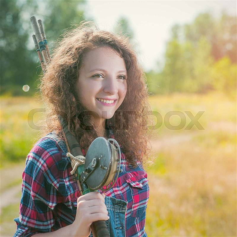 Fisher woman with wintage fishing pole, walking to the summer river, relaxation and leisure backgrounds , stock photo