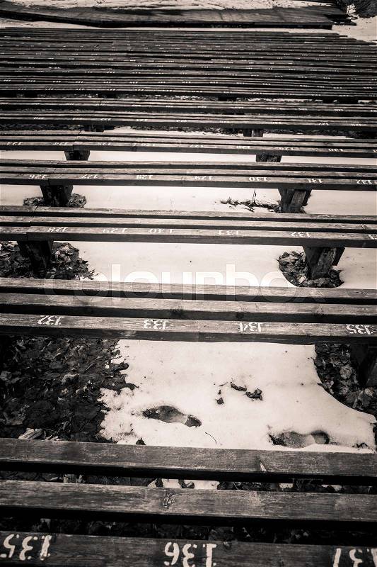 A beautiful monochrome pattern of wooden benches in rows, stock photo