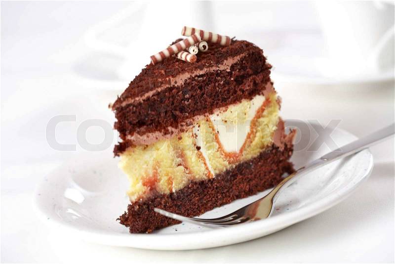 Piece of delicious chocolate cake filled with cream, stock photo