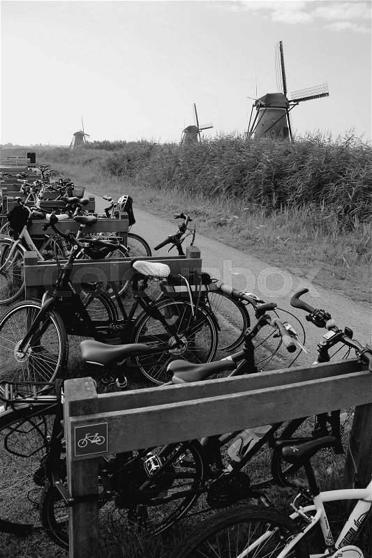 Parking place for bikes in the neighbourhood of the windmills at Kinderdijk in Holland in the summer in black and white, stock photo