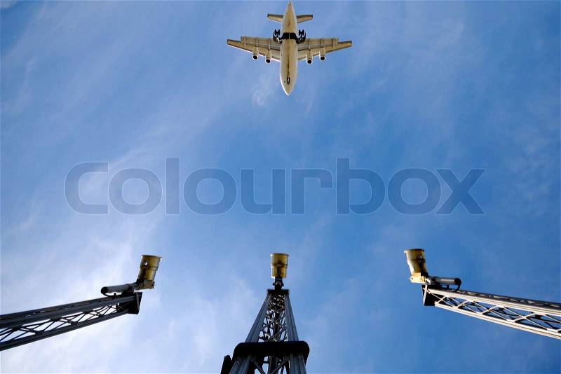 A plane is flying over landing lights in airport Note the plane is in motion blur and not in focus, stock photo
