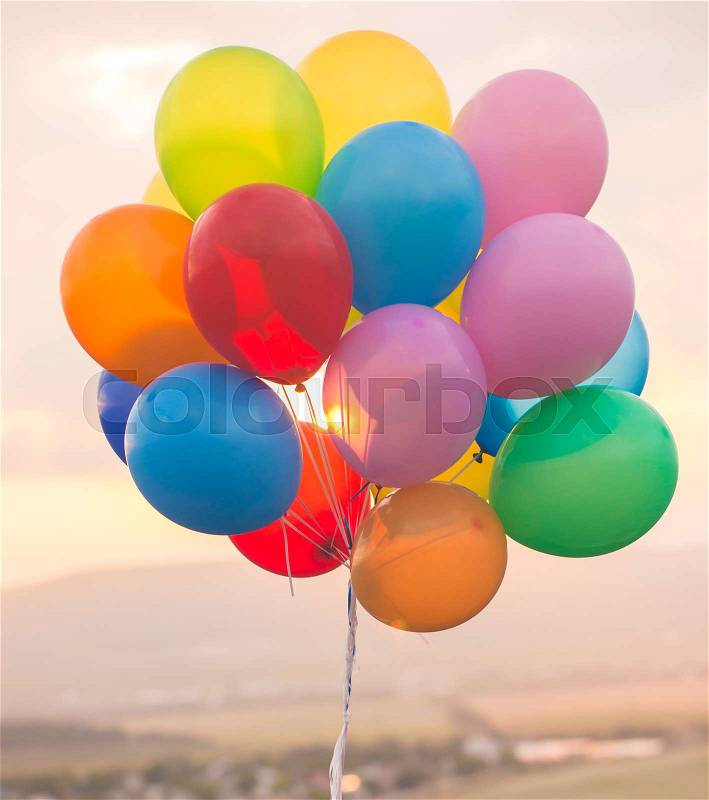 Bouquet of colorefull balloons outdoor photo on sunset, stock photo