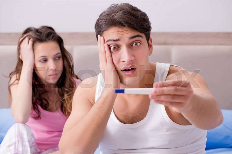 Young family with pregnancy test results, stock photo
