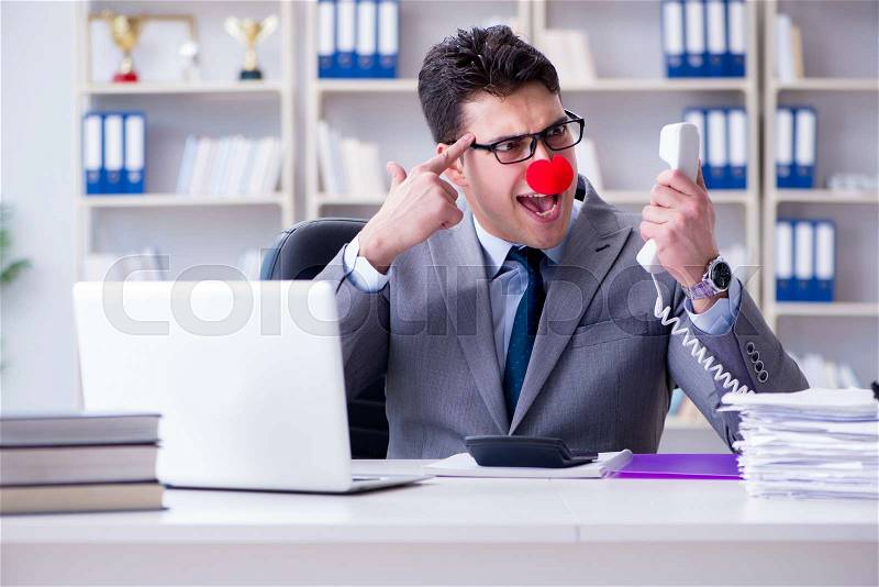 Clown businessman angry frustrated working in the office, stock photo