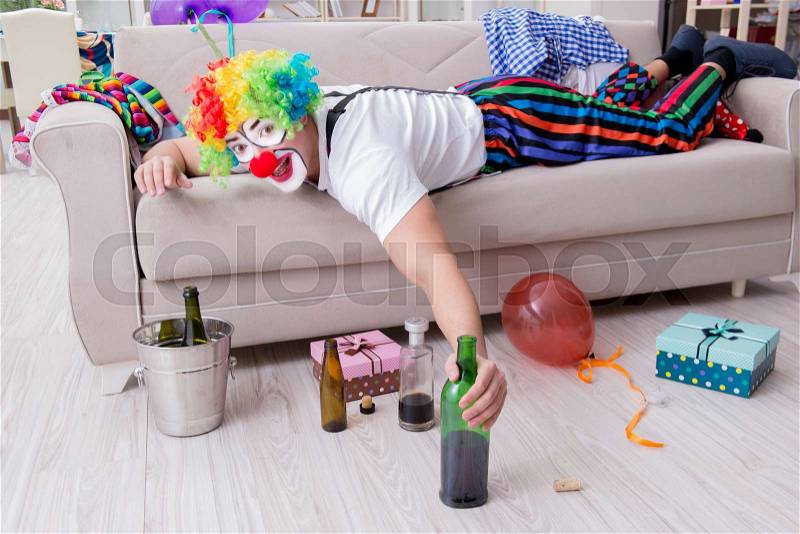 Drunk clown celebrating having a party at home, stock photo