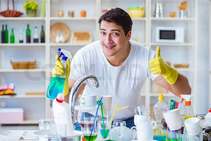 Man showing thumbs up washing dishes, stock photo