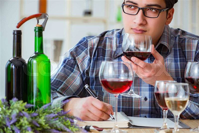 Professional sommelier tasting red wine , stock photo