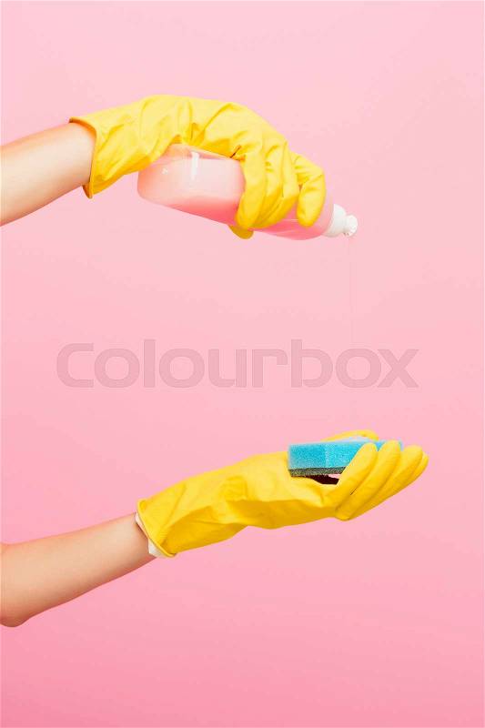 The woman's hand cleaning on a pink background. Cleaning or housekeeping concept background. Frame for text or advertising, stock photo