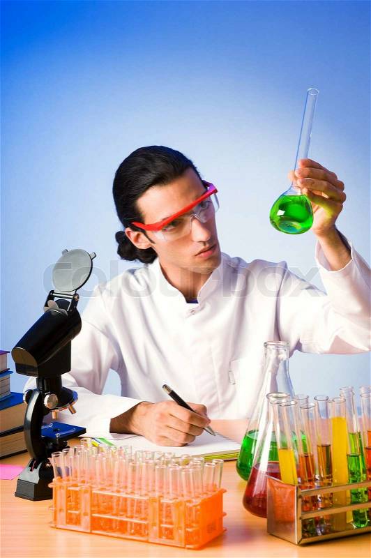 Chemist in the lab experimenting with solutions, stock photo