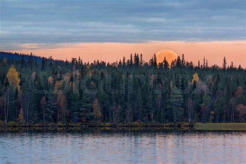 Morning autumn landscape with moonset and lake, Finland, Lapland, stock photo