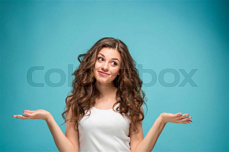 The young woman\'s portrait with happy emotions on studio background, stock photo