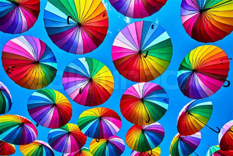 Rainbow umbrella on sky background. Many colorful umbrellas. umbrella street decoration, stock photo
