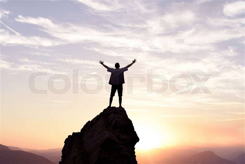 Man with arms raised in the sky winner success concept, stock photo