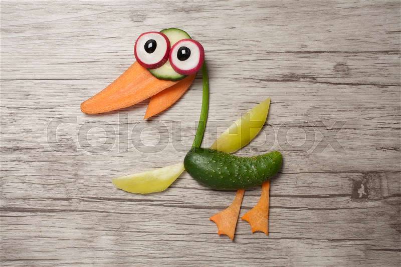 Duck compiled of raw vegetables on wooden board, stock photo