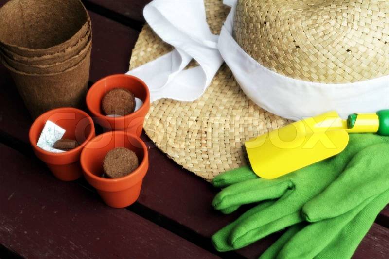 Gardening tool, gloves, straw hat and clay pots, stock photo