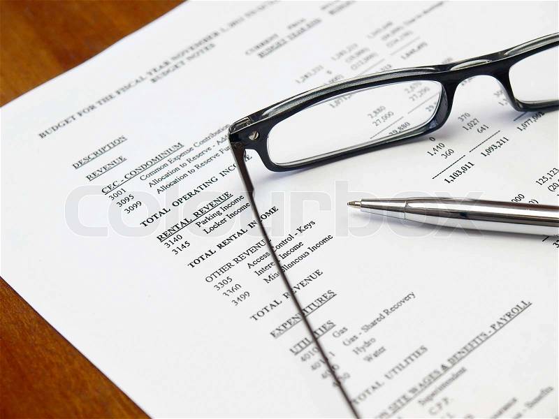 Glasses and pen on the budget document, stock photo