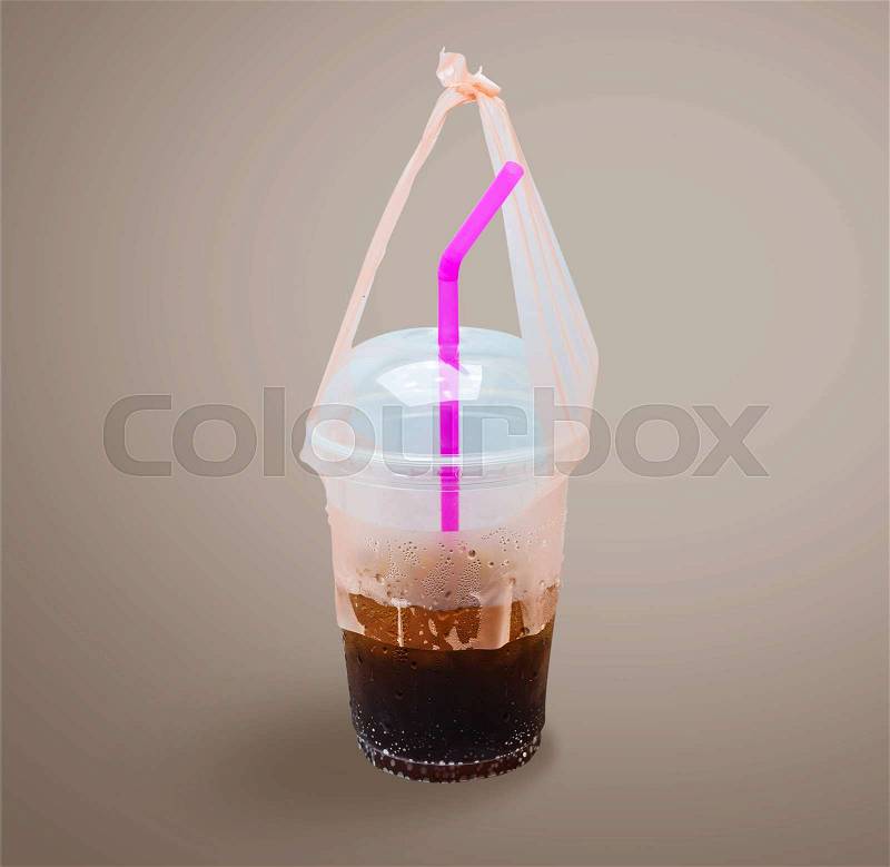 Plastic cup of soft drink isolated on gray background, with clipping path, stock photo