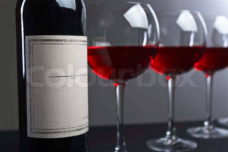 Bottle and glasses of red wine . Old paper label .Copy space . Free space for your text , stock photo