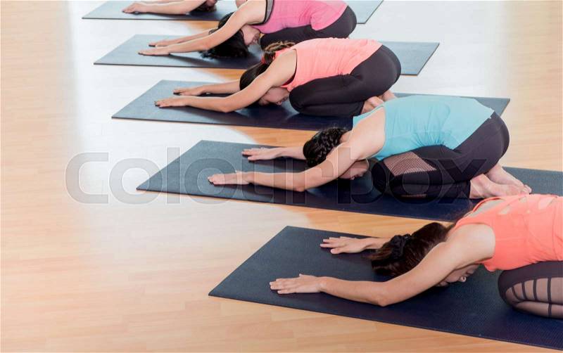 Close up group of people doing yoga child\'s poses in studio training room,Balasana poses,wellness and healthy lifestyle, stock photo