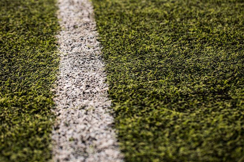 Green grass pattern for football sport, Football field, soccer field, team sport texture. White stripe on it. Close up focus, stock photo