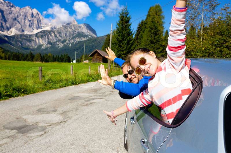 Happy dad and daughter looking out the car window and mountains in the background. Dolomites, Italy , stock photo