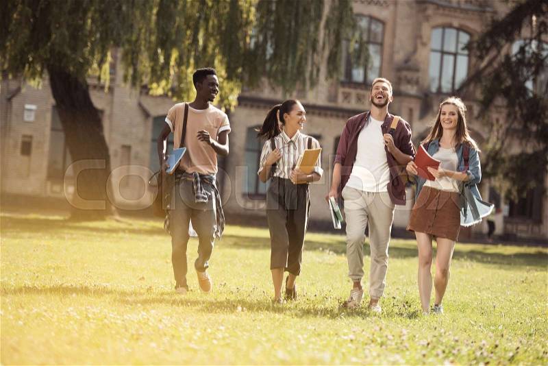 Group of happy multicultural students spending time together in park, stock photo