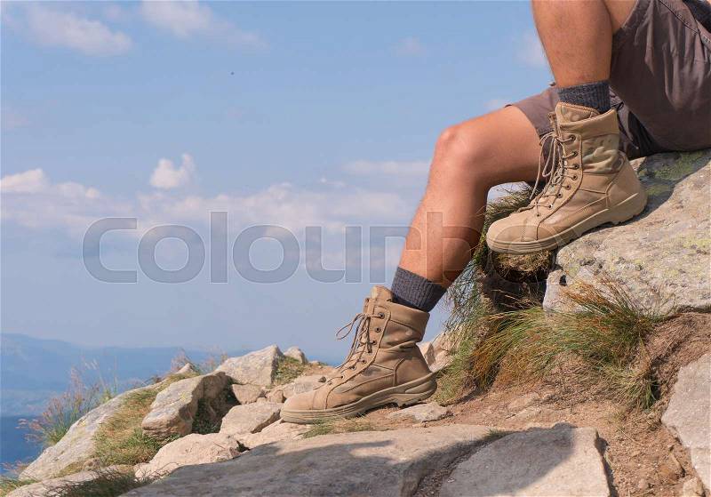 The guy in trekking beige boots. close-up, stock photo