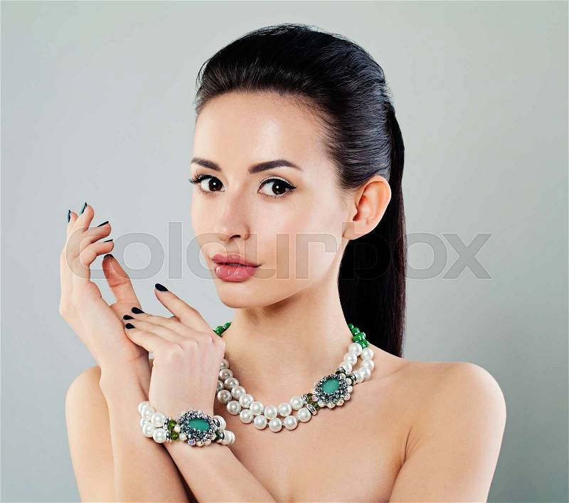 Nice Young Fashion Model Woman with Makeup, Manicure, Jewelry Necklace and Bracelet, stock photo