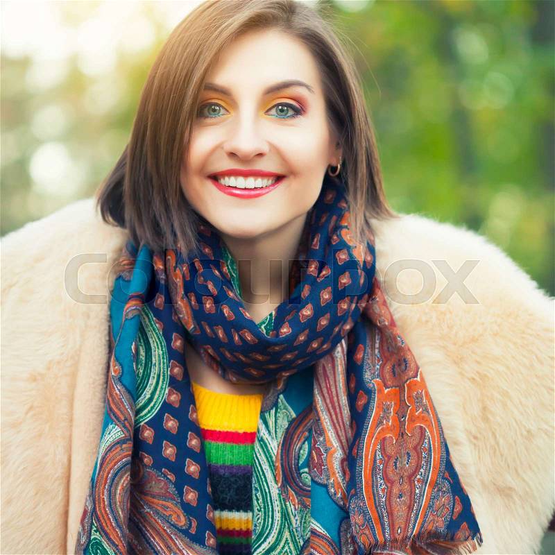 Young woman posing in autumn park, stock photo